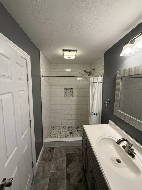 Remodeled bathroom with tiled shower