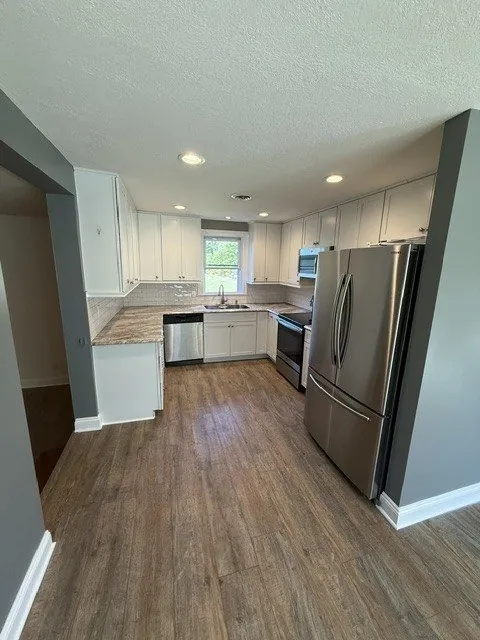 Full kitchen remodel with white cabinets and island
