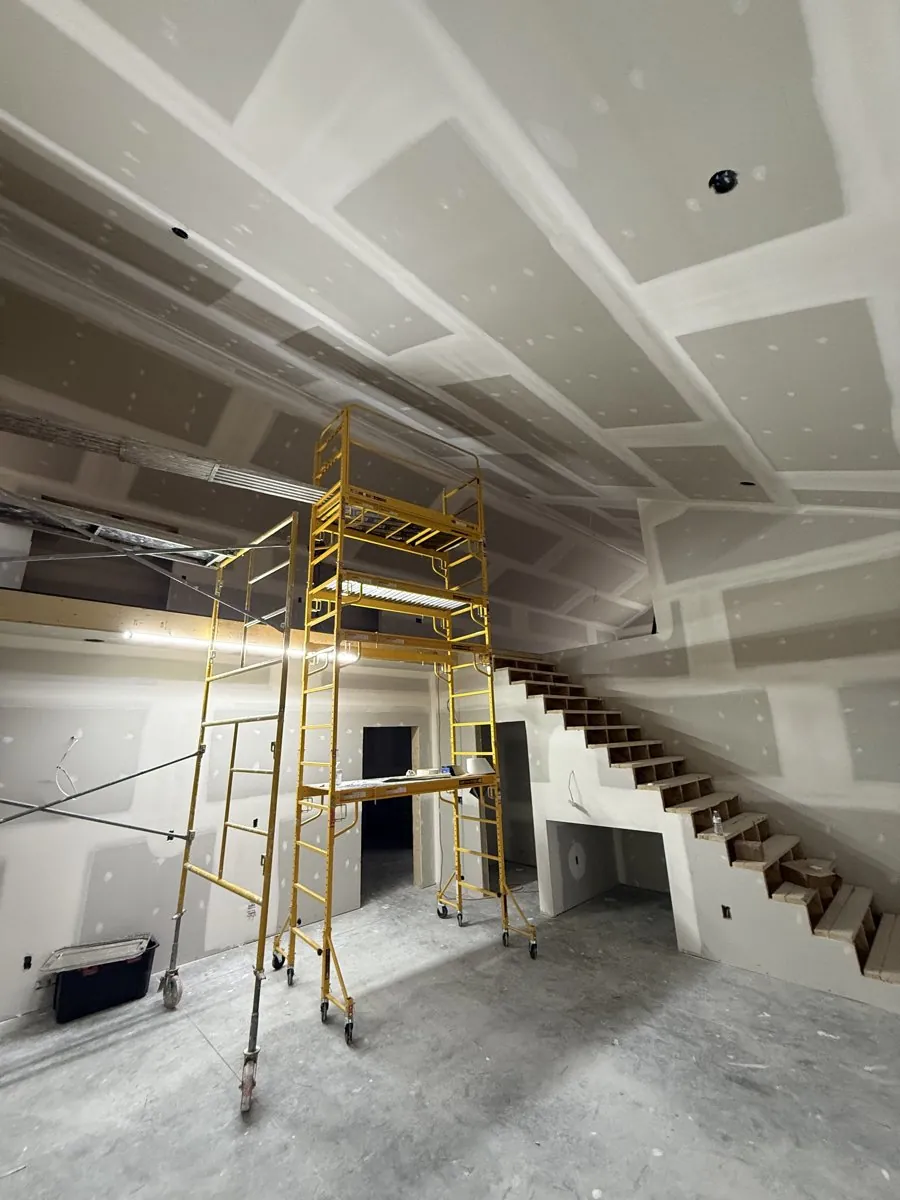 New construction drywall with vaulted ceiling and staircase
