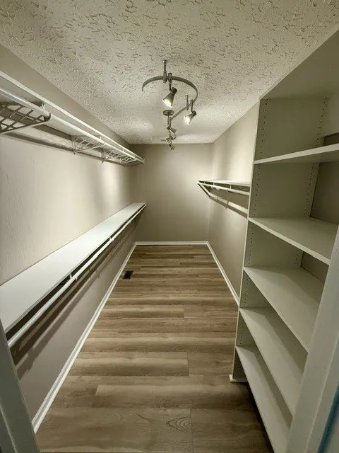 River Rock walk-in closet finished by Precision Building Group